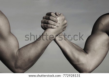Rivalry, vs, challenge, strength comparison. Two men arm wrestling. Arms wrestling, competition. Rivalry concept - close up of male arm wrestling. Leadership concept. Black and white.