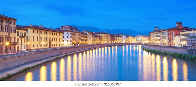 River Arno at night in Pisa, Italy.