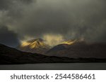 River Ba with mountain peaks of Meall a´Bhüiridh and Clach Leathad in the background and dramatic clouds, Glen Coe, Rannoch Moor, west Highlands, Scotland, United Kingdom, Europe