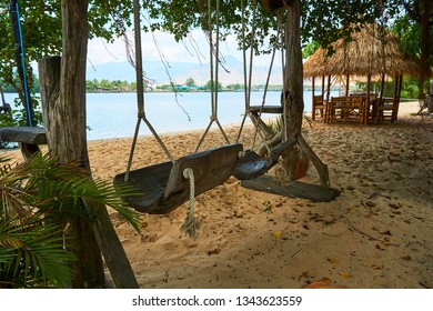 River beach with straw hut and swing in Kampot Cambodia - Powered by Shutterstock