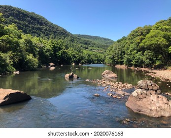 Caí River Beteen Stones And Green Trees In A Sunny Day, Nova Petrópolis, Brazil