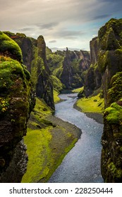 River between green mossy cliffs