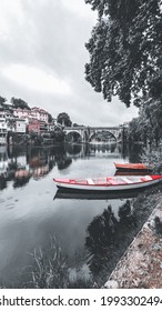 Tâmega River With Boats, Trees, Houses And A Bridge 