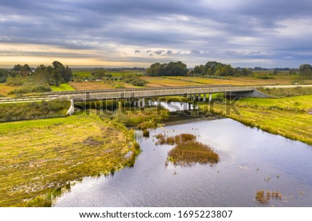 River bridge with wildlife underpass for otters and other aquatic wildlife in national park Weerribben Wieden marshland swamp, Overijssel, Netherlands.
