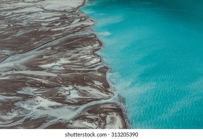 River Delta Flowing Into The Blue Pond. Top View. Aerial Photography.