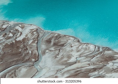 River Delta Flowing Into The Blue Pond. Top View. Aerial Photography.