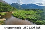 River flowing with clear water and surrounded by big mountains and clouds