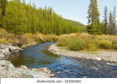 River flowing through mountain landscape in Yellowstone National Park.