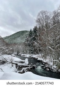 River Flowing Through A Snowy Hillside