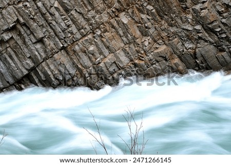 A river flowing through a valley and columnar jointed rocks