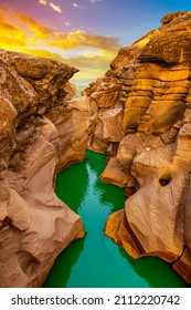 the river flowing through the valley of huge red rocks. Canyon view at sunset. extraordinary natural scenery. Nature landscape in the canyon. View of the stream flowing from the valley.