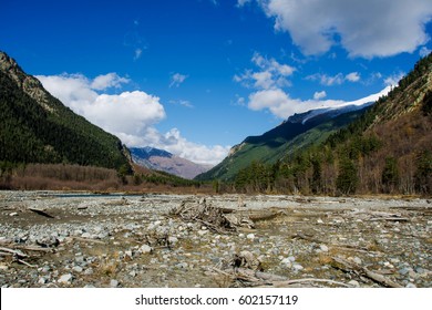 The river flows between the mountains