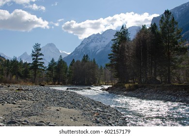The river flows between the mountains