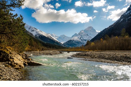 The river flows between the mountains