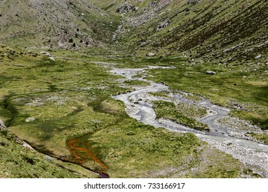 a river flows between the mountains