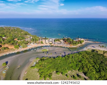 River flows into Back Bay of Indian Ocean near Nilaveli beach in Trincomalee, Sri Lanka.  Trincomalee is coastal resort city. Panoramic Top View on beach in Trincomalee.