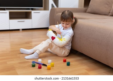 River Fracture In A Child. A Little Girl Paints On Plaster, Bandages.
