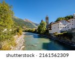 The river Inn runs through Susch. It lies in the Lower Engadine Valley. From there you can take the Flüela Pass towards Davos (central Graubünden). The tower of the Reformed Church can be seen.