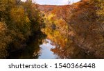 river landscape with colorful autumn trees reflected in the Cuivre river in Cuivre river state park near Troy, MO