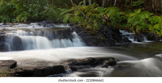 River In Maine Running Over Boulders In A Thick Forest