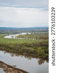River Meanders Through Lush Floodplain, Aerial Panorama Highlighting Winding Channel And Sandbar Formations, Spring Foliage And Marsh Edges, Reflective Water Under Soft Overcast Sky Suited
