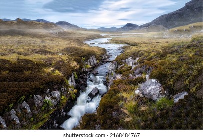 A river in a mountain valley. River valley in mountains. River valley landscape. River valley panorama