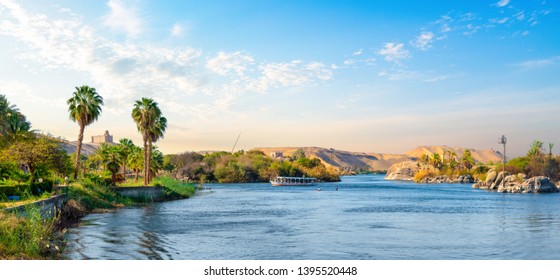 River Nile and boats at sunset in Aswan - Shutterstock ID 1395520448