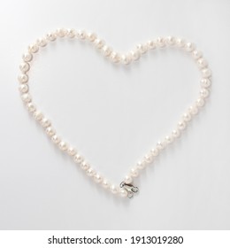 river pearls in the shape of a heart on a white background