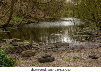 River Pollution In UK With Tyres Tires And Plastic Bottles