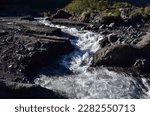 River rapids in a volcanic area - Very strong river
The image captures the raw power and energy of a river in a volcanic area as it rushes through a series of rapids. The water appears to be boiling