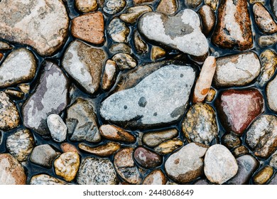 River rocks partially wet in water - Powered by Shutterstock