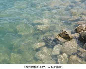 River rocks and stones in calm waters at the nature park shore