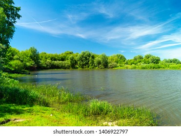 River in rural terrain at spring length of time on background blue sky - Shutterstock ID 1406922797