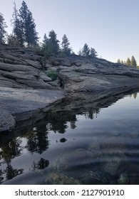 River Shoreline Against The Rocky Terrain