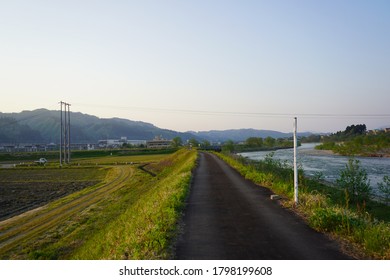 River Side Road With New Growth Grass. A Path For Those Who Like Exercising And Walking 