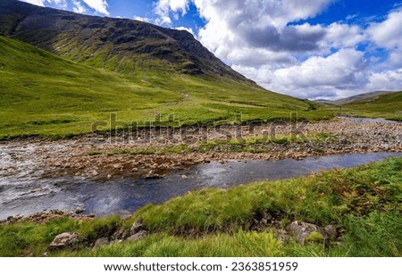 A river stream in a mountain valley. Mountain valley river stream. River stream in mountains. Mountain valley stream