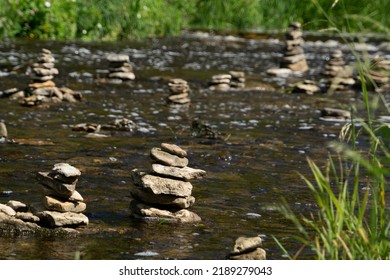 River With Stream, Plants And Rock Sculptures (Piles Of Stones) 