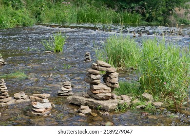 River With Stream, Plants And Rock Sculptures (Piles Of Stones) 