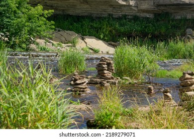 River With Stream, Plants And Rock Sculptures (Piles Of Stones) 