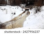 the river struggles with a thick layer of ice in winter