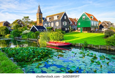 River in summer village. Housing on hill, rural meadow riverside view - Shutterstock ID 1650589597