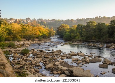 The River Swale with autumn foliage and houses of Richmond, North Yorkshire in the background - Shutterstock ID 2218808595