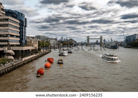 River Thames With Tower Bridge And Warship Belfast In Front Of London Skyline With Modern Skyscrapers In The United Kingdom