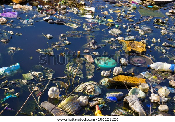 River that is polluted with various garbage\
and trash, Polluted rivers,\
photography