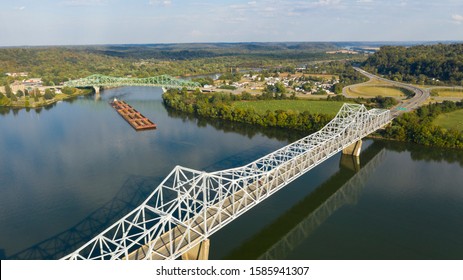 A river Tugboat pushes barge contents down the Ohio River south of Henderson West Virginia