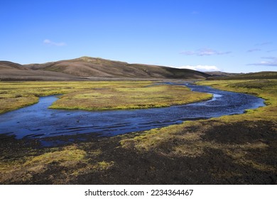 river under blue sky in the green plateau of iceland 