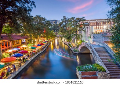 River walk in San Antonio city downtown skyline cityscape of Texas USA at sunset - Shutterstock ID 1851821110