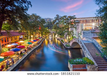 River walk in San Antonio city downtown skyline cityscape of Texas USA at sunset