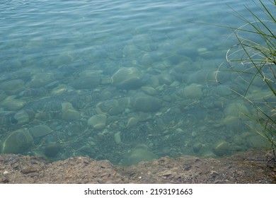 
river water, stones and ledge, place to bathe. water background and textures