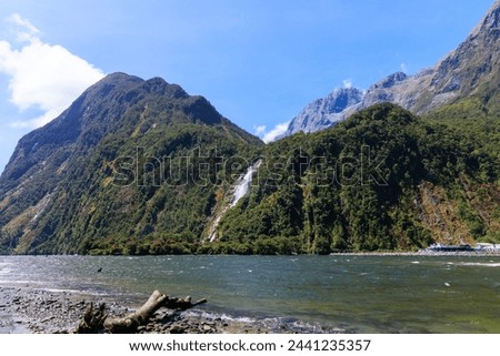 River and waterfall near milfordsound with blue sky in fine day in summer